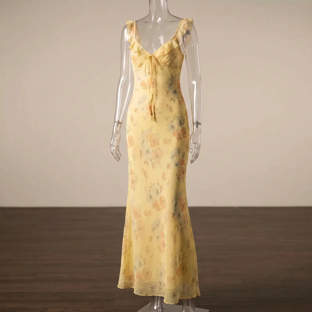 Aethelgard floral maxi dress in pale yellow with a plunging V-neck, ruffled trim, adjustable tie front, and mermaid hem. This elegant, sleeveless chiffon dress features a romantic floral print, ideal for summer evenings.