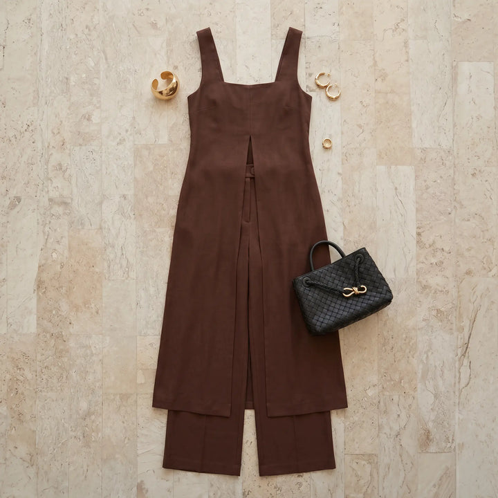 Arvyla dark chocolate brown linen blend wide-leg trouser set with sleeveless square-neck top, styled with a black woven handbag and gold jewelry.