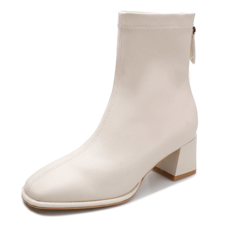Axorian beige ankle boot featuring a square toe, 4.5cm block heel, and rear zipper, shown in a front three-quarter view with a graphic indicating fleece lining.