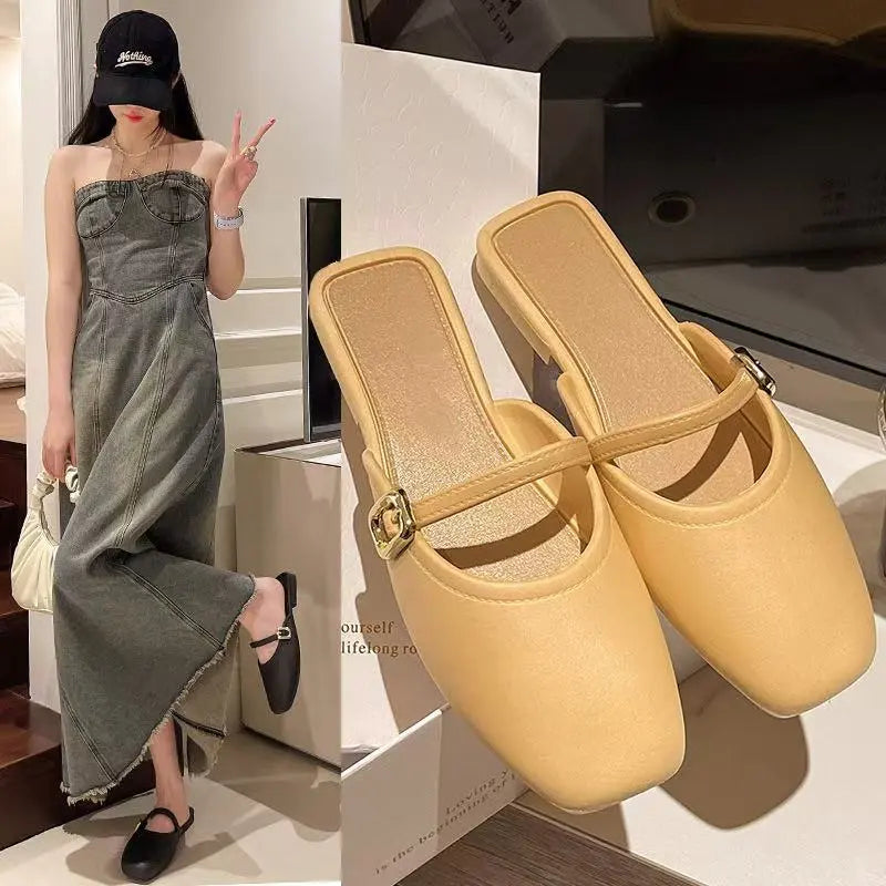 Matte faux leather square-toe mules in a soft ivory color, featuring a thin strap with a polished gold-tone square buckle and a low block heel.