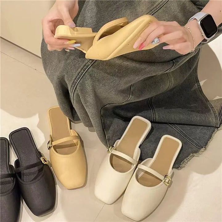 Three pairs of Azoria mules in ivory, beige, and black, with a hand holding one beige mule, showcasing the square toe and gold buckle detail.