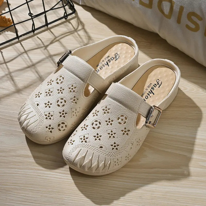 Pair of Azova off-white textured synthetic mules with embossed geometric pattern, round toe, and adjustable gold buckle strap.