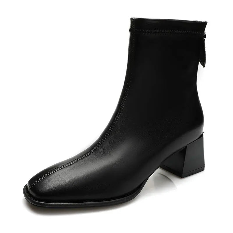 Axorian black faux leather ankle boots featuring a modern square toe, comfortable block heel, and convenient rear zipper closure, presented from a front view.