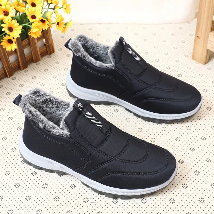 Black slip-on winter boots with plush faux fur lining, Quilted water-resistant upper, and a durable rubber outsole.