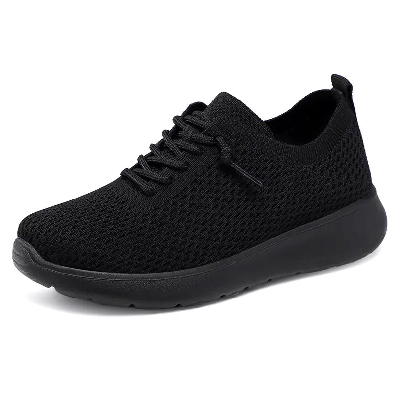 Black engineered knit mesh low-top sneakers with a round toe, lace-up closure, and a comfortable matte black EVA sole, presented on a clean white background.