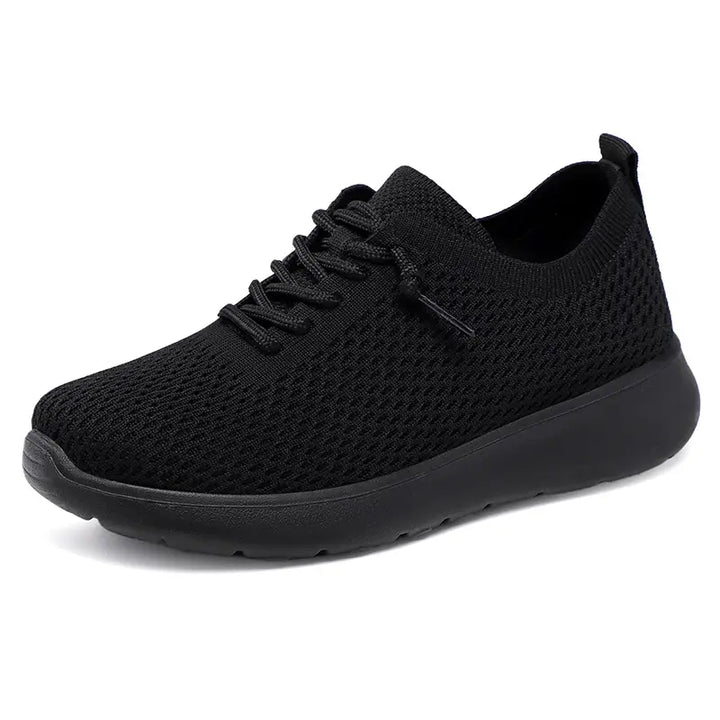 Black engineered knit mesh low-top sneakers with a round toe, lace-up closure, and a comfortable matte black EVA sole, presented on a clean white background.