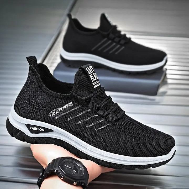 Black lightweight breathable knit sneakers with white midsole stripe and &