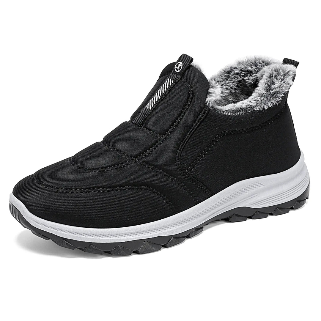 Black quilted Lycra winter boot with fluffy faux fur lining, white midsole, and dark red textured outsole, shown in a three-quarter view.