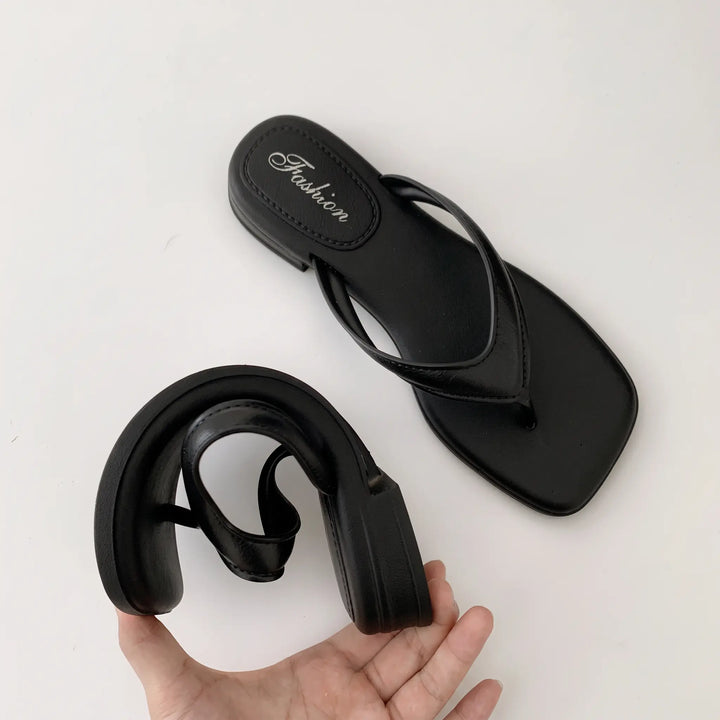 Black square-toe thong sandals with a subtle embossed &