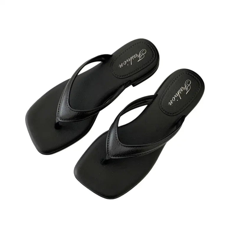 Black women's thong sandals with a chic square toe and a subtle low wedge heel, featuring an embossed 'Fashion' logo on the footbed.