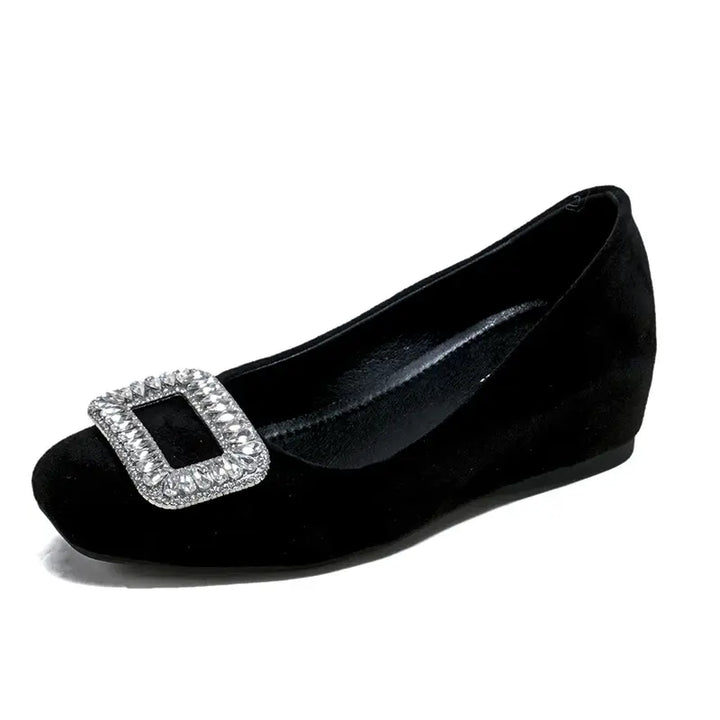 Black suede slip-on wedge flats for women, featuring a rounded-square toe and a prominent crystal-embellished square buckle on the vamp.