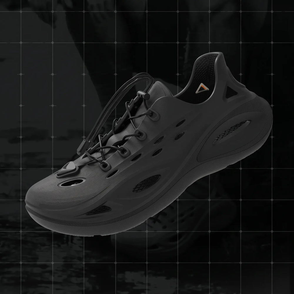 Brakko athletic EVA slides in Phantom Black, showcasing a three-quarter view with adjustable bungee laces and a chunky geometric outsole. Features include a waterproof molded construction and ventilated design.