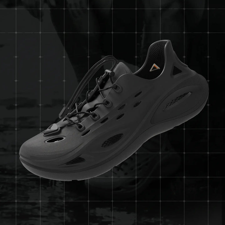 Brakko athletic EVA slides in Phantom Black, showcasing a three-quarter view with adjustable bungee laces and a chunky geometric outsole. Features include a waterproof molded construction and ventilated design.