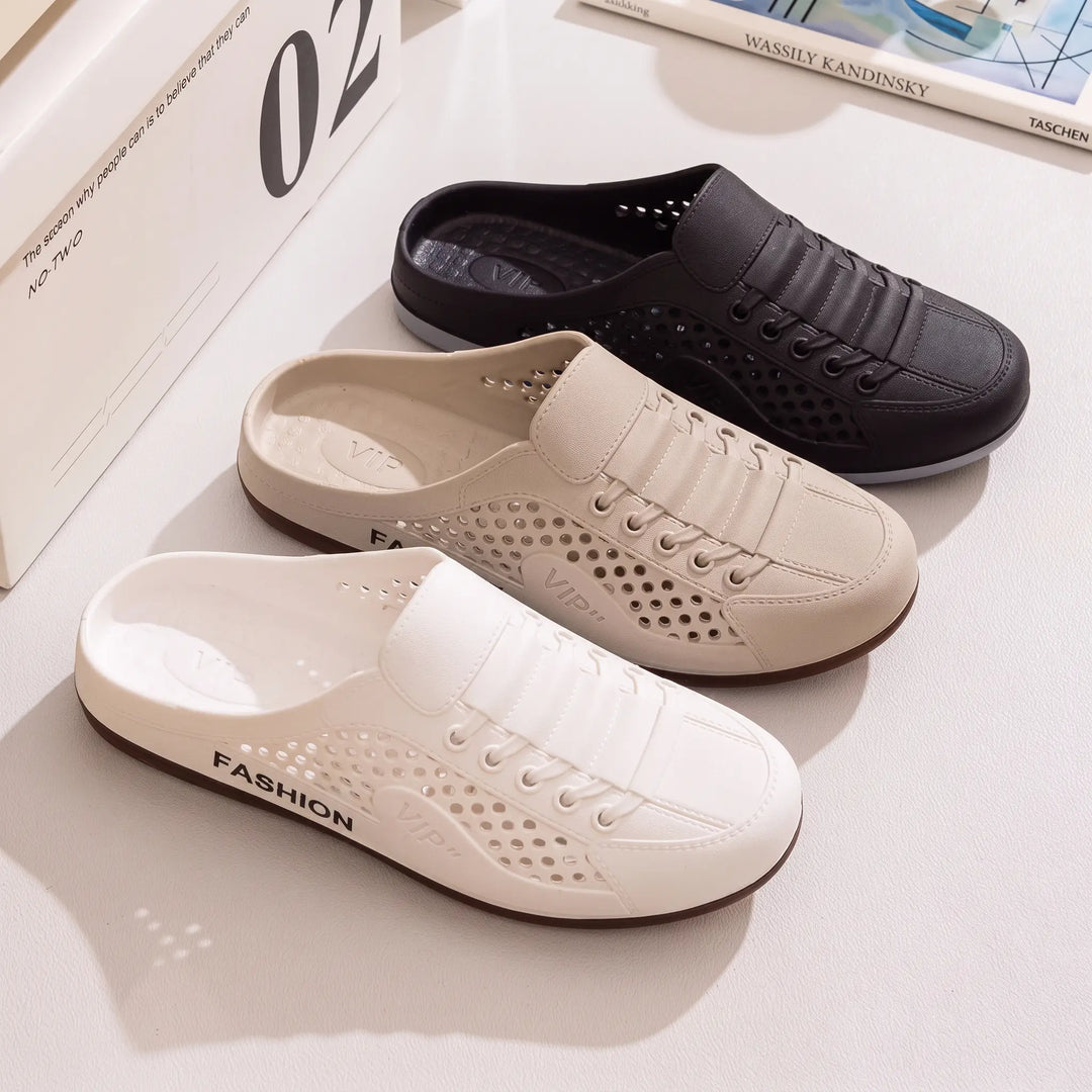 Three pairs of breathable, ventilated mule clogs in white, beige, and black, showcasing their perforated design and slip-on style. These casual summer slides feature a faux lace-up detail and dark brown rubber outsoles.