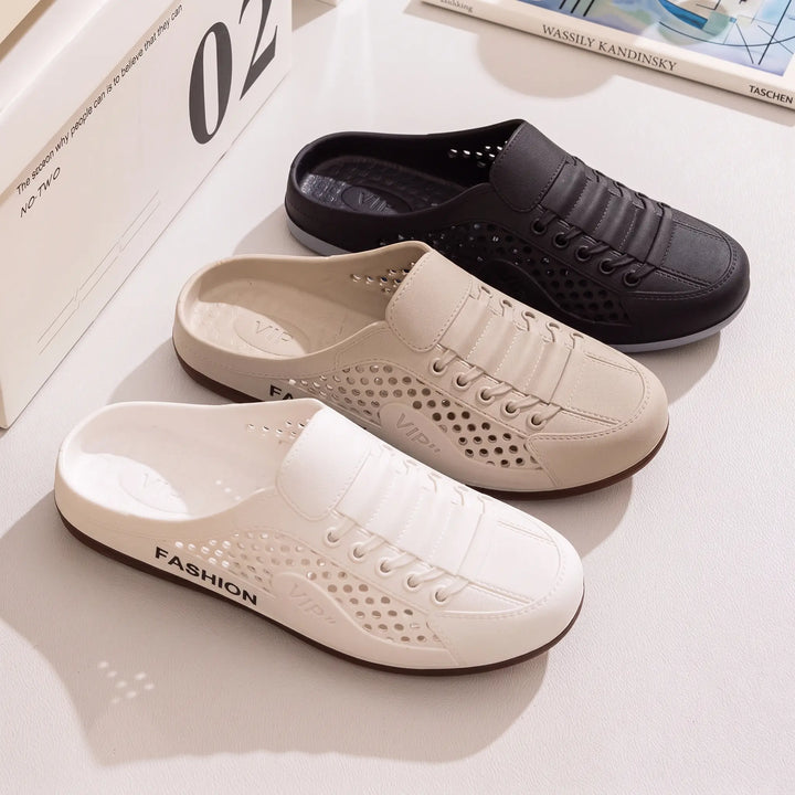 Three pairs of breathable, ventilated mule clogs in white, beige, and black, showcasing their perforated design and slip-on style. These casual summer slides feature a faux lace-up detail and dark brown rubber outsoles.