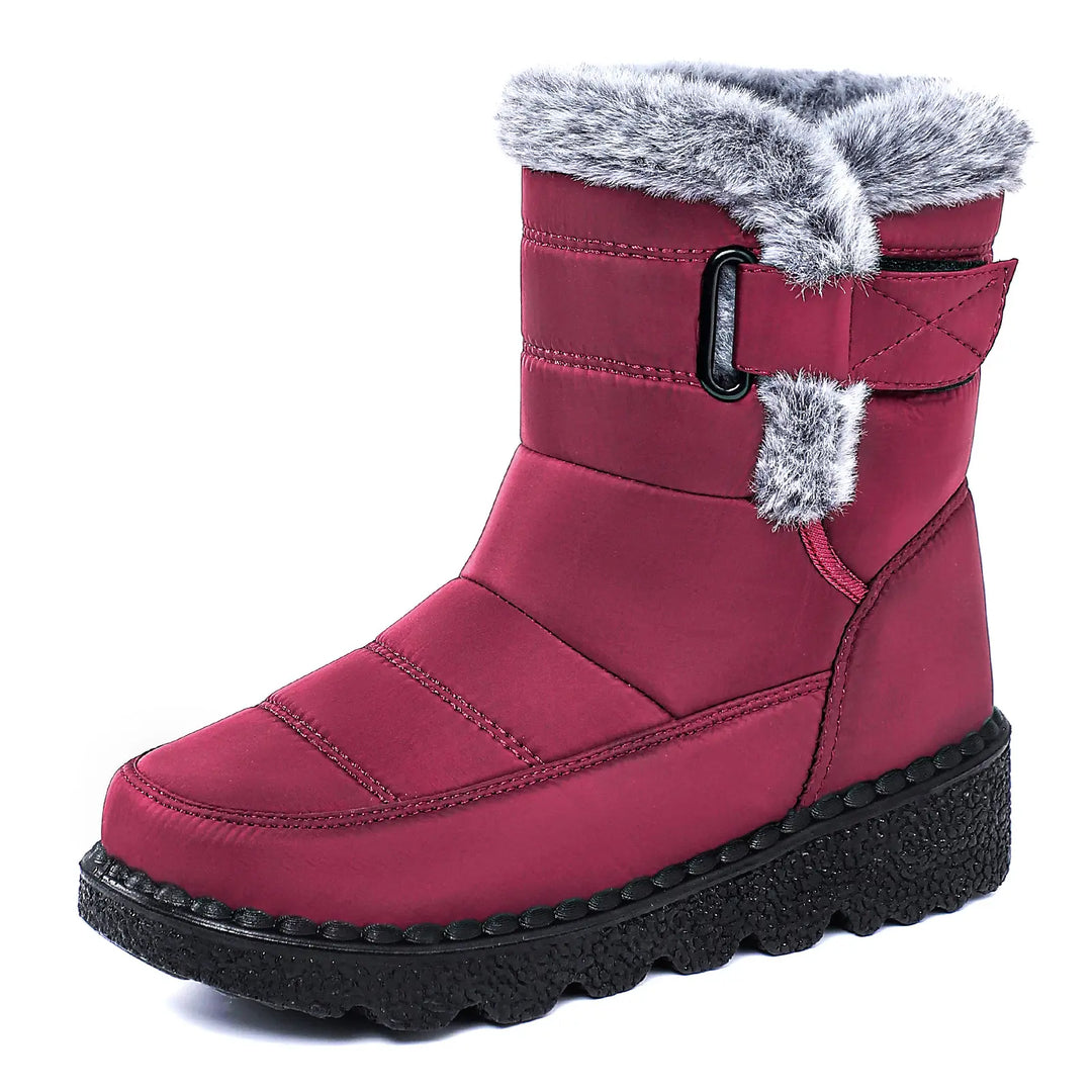 Burgundy mid-calf winter boots featuring a water-resistant quilted fabric upper, plush faux fur lining, side zip, adjustable buckle strap, and a thick lugged platform wedge sole.