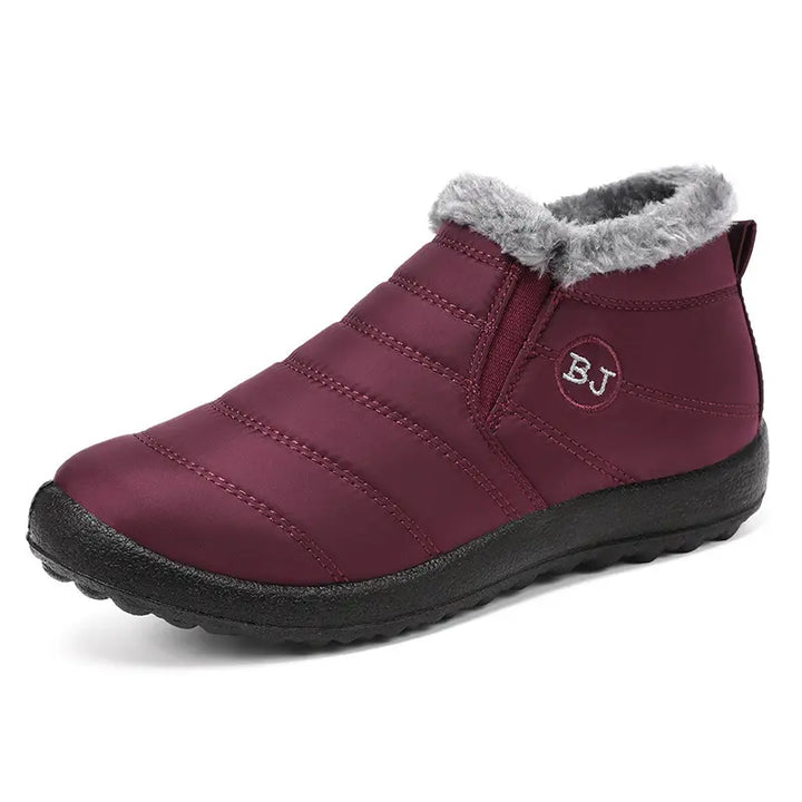 Burgundy quilted waterproof winter ankle boots with a faux fur lining and a prominent &
