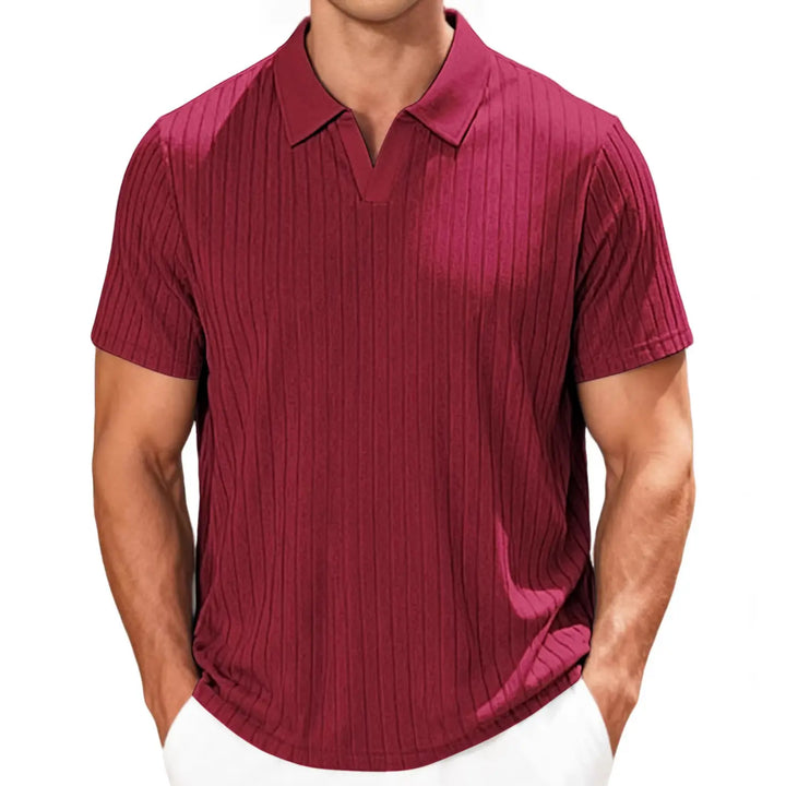 Man wearing a relaxed-fit, short-sleeved burgundy textured knit polo shirt with an open V-neck collar against a white background.