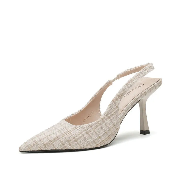 Chic pointed-toe slingback heels in textured tweed-like fabric, featuring a slender stiletto heel and an adjustable buckle strap, presented in a sophisticated light beige hue.
