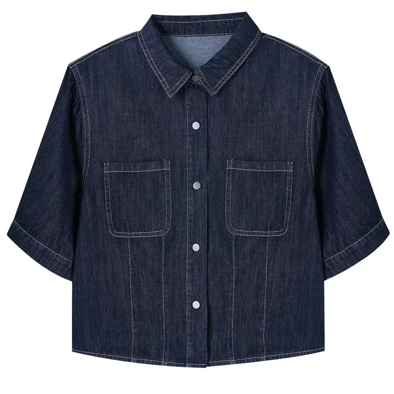 Dark wash cropped denim shirt jacket with short sleeves, pointed collar, contrast stitching, silver snap buttons, and two chest pockets.