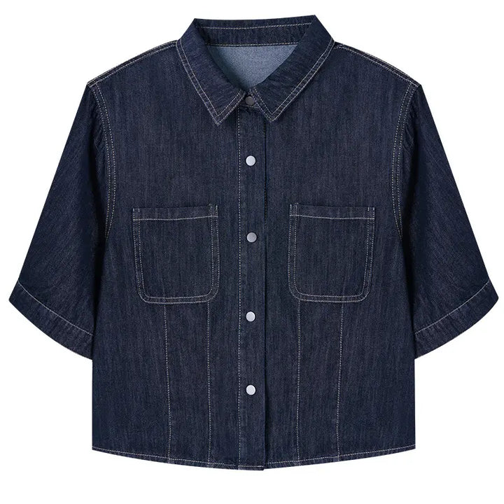 Dark wash cropped denim shirt jacket with short sleeves, pointed collar, contrast stitching, silver snap buttons, and two chest pockets.