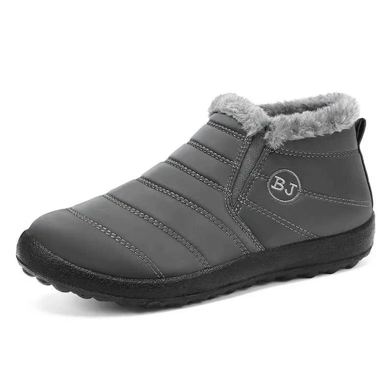 Faelan unisex matte black quilted nylon waterproof winter ankle boots with grey faux fur lining and elasticated side gore panels, shown in a front-three-quarter view.