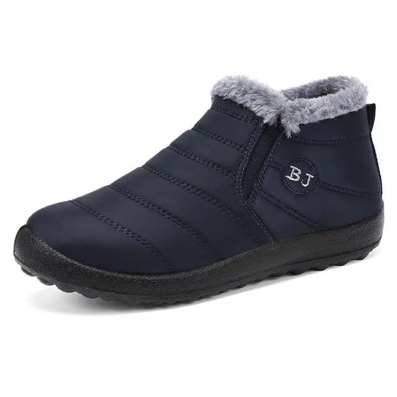 Faelan navy blue waterproof winter ankle boots featuring a quilted nylon upper, plush grey faux fur lining, and easy slip-on side gore panels with a subtle &