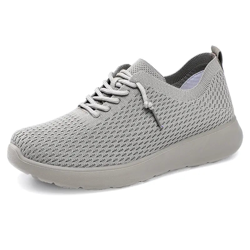 Grey lightweight breathable engineered knit trainers for men, featuring a sock-like fit, lace-up closure, and a sculpted EVA sole. Modern athleisure footwear.