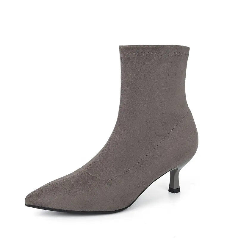 Grey suede-like stretch sock ankle boot with a pointed toe and slender stiletto heel, presented from a side view.