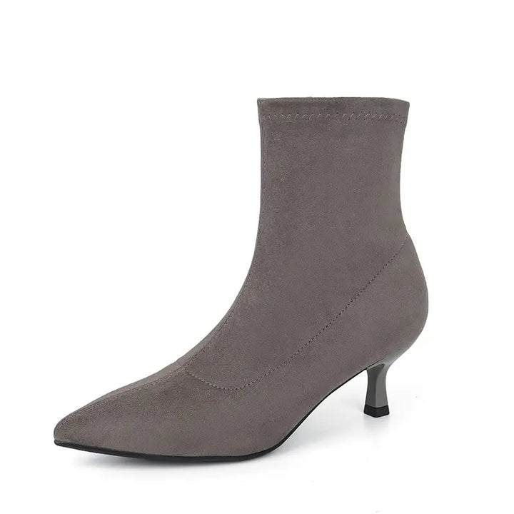 Grey suede-like stretch sock ankle boot with a pointed toe and slender stiletto heel, presented from a side view.