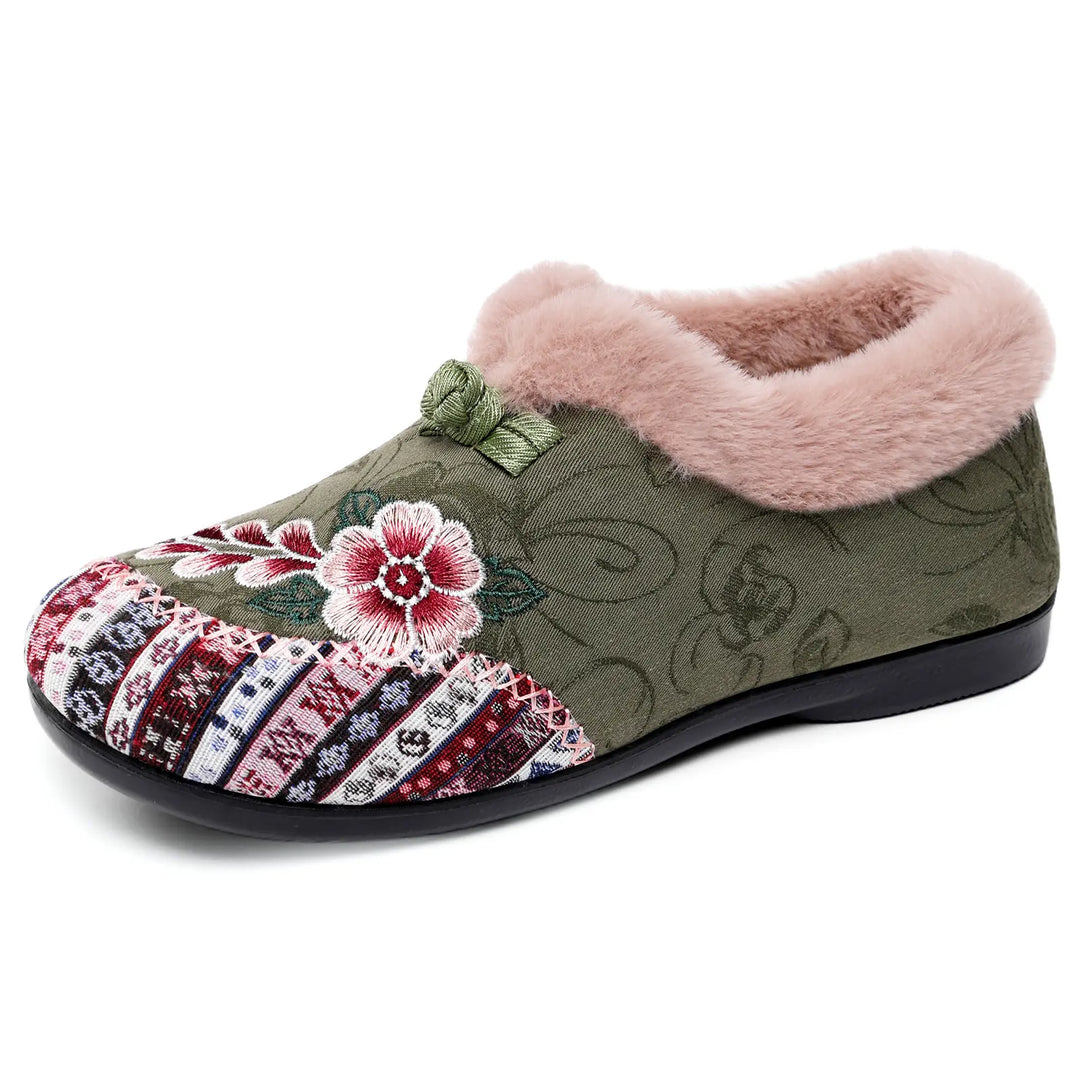 One Grivan embroidered mule slipper in charcoal grey, featuring plush pink faux-fur trim, colorful floral embroidery on the vamp, and a geometric band.