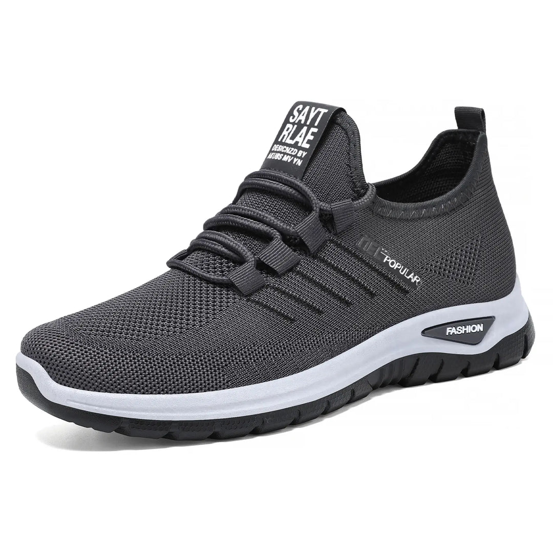 Gryphos deep grey breathable mesh sneakers with white midsole and dark outsole, shown from a three-quarter front view.