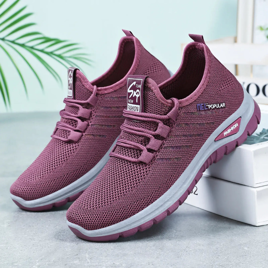 Pair of deep purple Gryphos breathable mesh sneakers with elastic laces and white contrasting midsole, shown at a three-quarter angle.