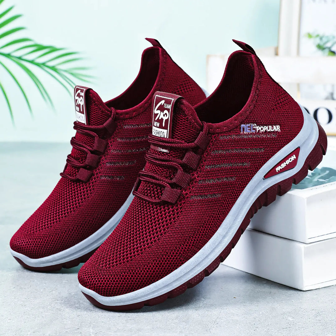 Pair of deep purple Gryphos breathable mesh sneakers shown from a three-quarter angle, featuring a white midsole and dark tread outsole.