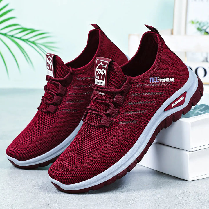 Pair of deep purple Gryphos breathable mesh sneakers shown from a three-quarter angle, featuring a white midsole and dark tread outsole.