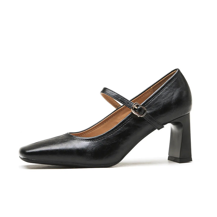 Black Kaelan Mary Jane block heel shoes with a square toe and single buckle strap shown from the side on a white background.