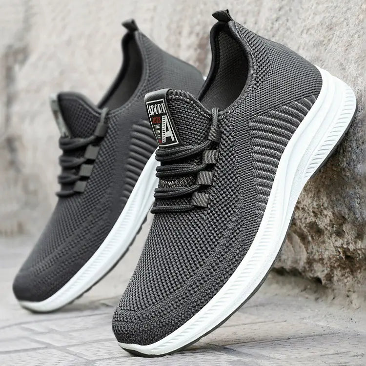 Two Kaelan men's lightweight breathable sneakers in charcoal grey knit mesh with white midsoles and black rubber outsoles, shown from a three-quarter angle.