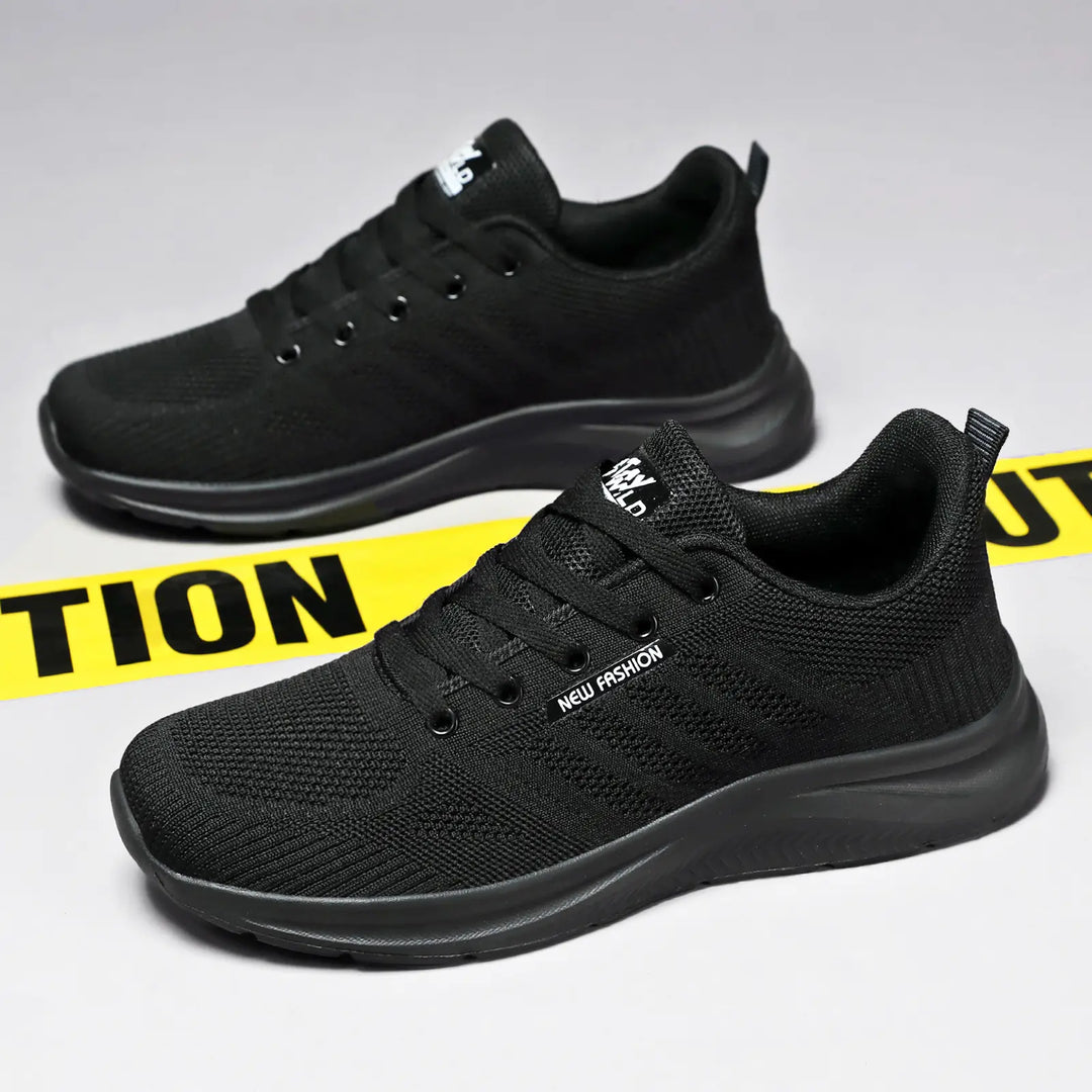 Pair of black Kaelen breathable mesh trainers viewed from a three-quarter angle, showcasing the lightweight design and lace-up closure.