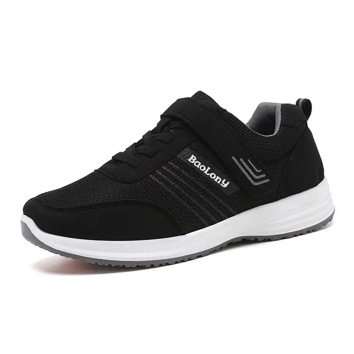 Kaelen black breathable mesh walking sneaker with dual closure system, white midsole, and grey outsole.