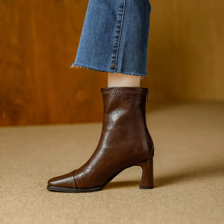 Brown Kaelen ankle boots with a chic square toe and 7cm block heel, shown on a model wearing cropped jeans.