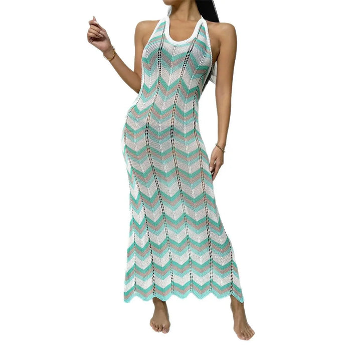 Kaelen artisanal chevron knit halter maxi dress with an open back, showcasing vibrant mint, white, and grey stripes and a scalloped hem. Model stands on a white background.