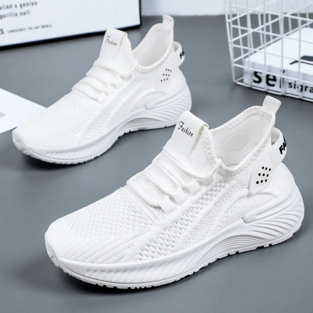 Pair of Kaelen women's white breathable knit mesh casual sneakers with lace-up closure and cushioned synthetic sole, shown from a three-quarter angle.