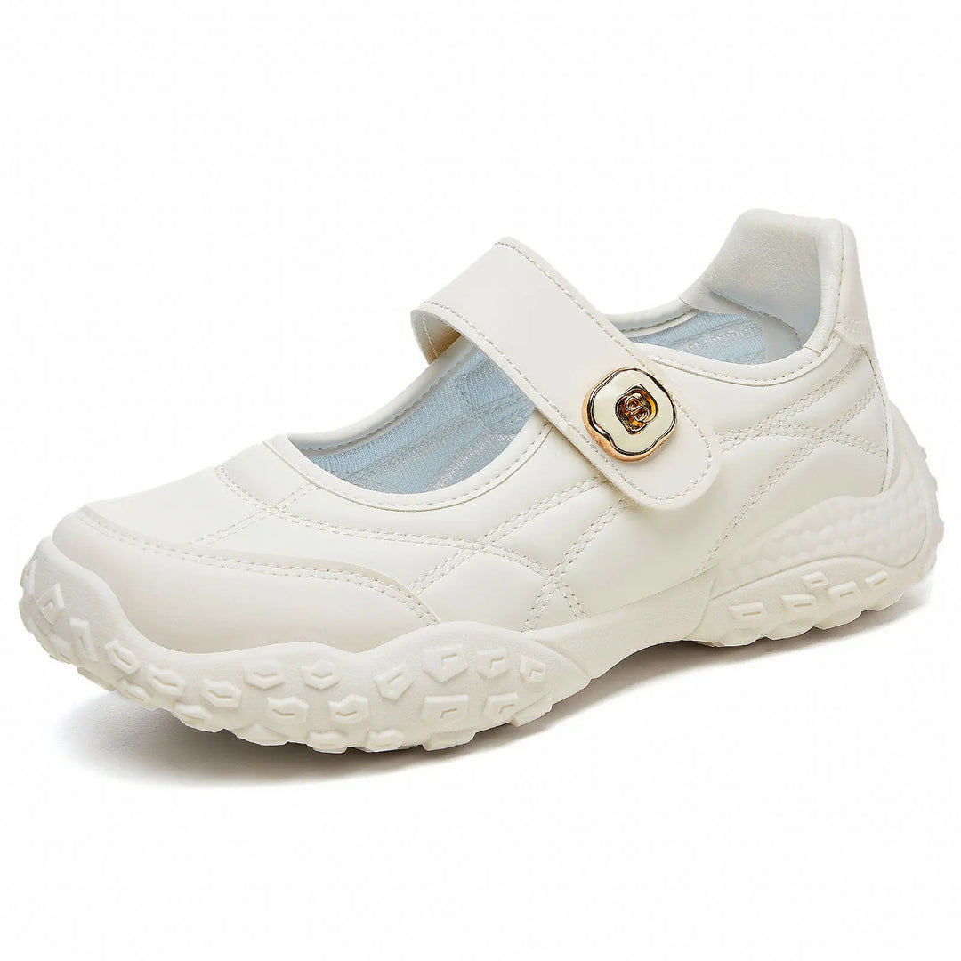 Cream white quilted synthetic leather Mary Jane flats with a decorative gold-tone buckle and an adjustable hook-and-loop strap, presented in a three-quarter view on a white background.