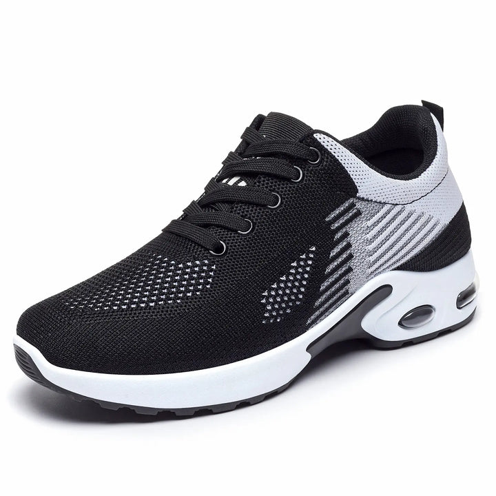 Black Kaelix breathable knit trainers with a white and light grey abstract stripe pattern, featuring white laces and a visible air cushioning unit in the heel.