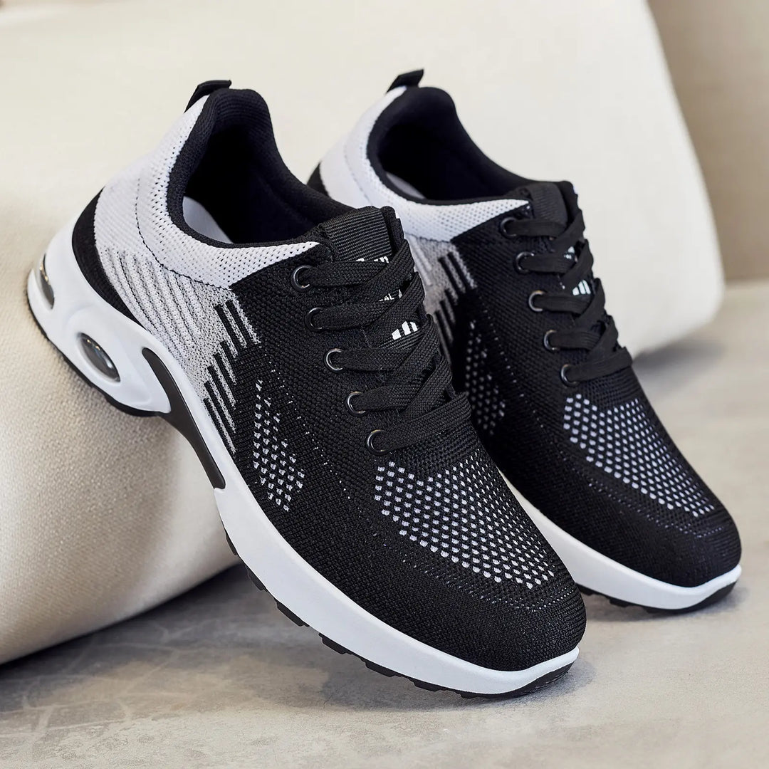 Kaelix breathable knit trainers in black and white with abstract stripe pattern and visible air cushioning heel, shown in a three-quarter view.