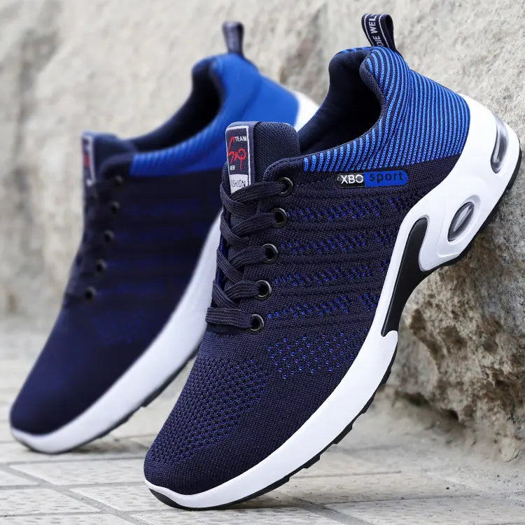 Three-quarter view of Kaelix men's breathable sneakers in black and red abstract knit mesh with a white midsole and visible air cushioning.