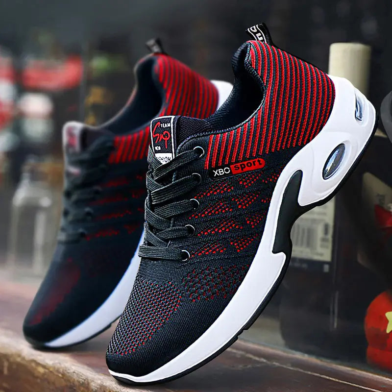Men's Kaelix black and red breathable mesh sneakers shown from a three-quarter angle with a visible white midsole and air cushioning unit.