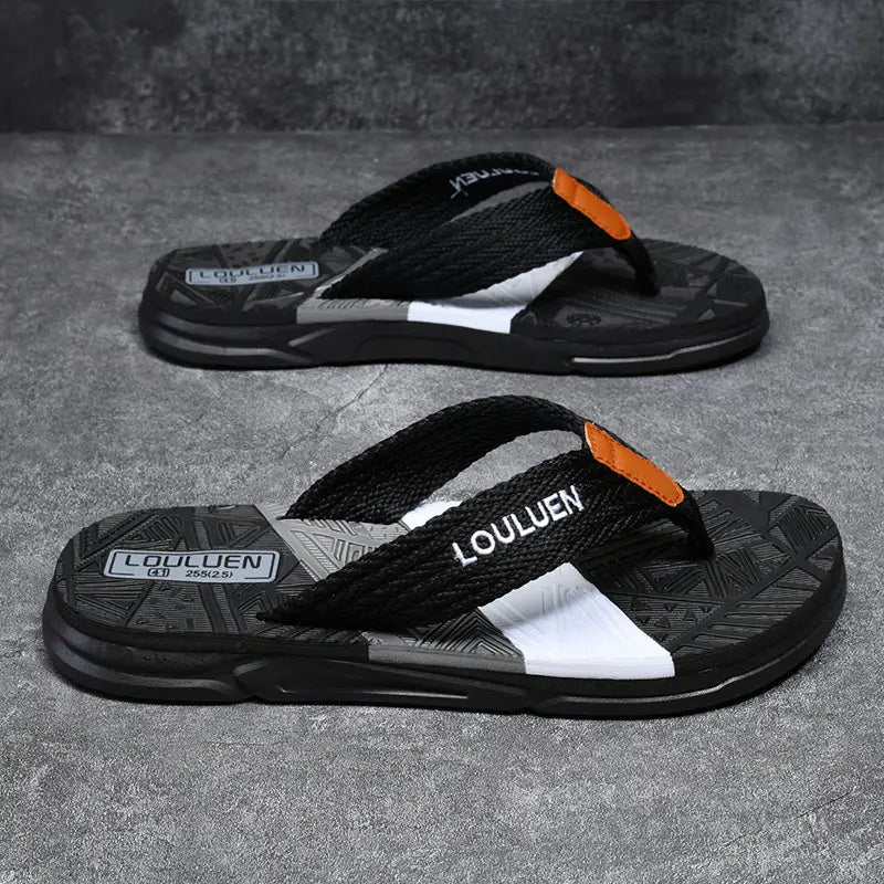 Pair of Kaelix Men's Casual Comfort Flip-Flops in black with a deep blue woven strap featuring white 'LOULUEN' embroidery and a multi-colored layered sole.