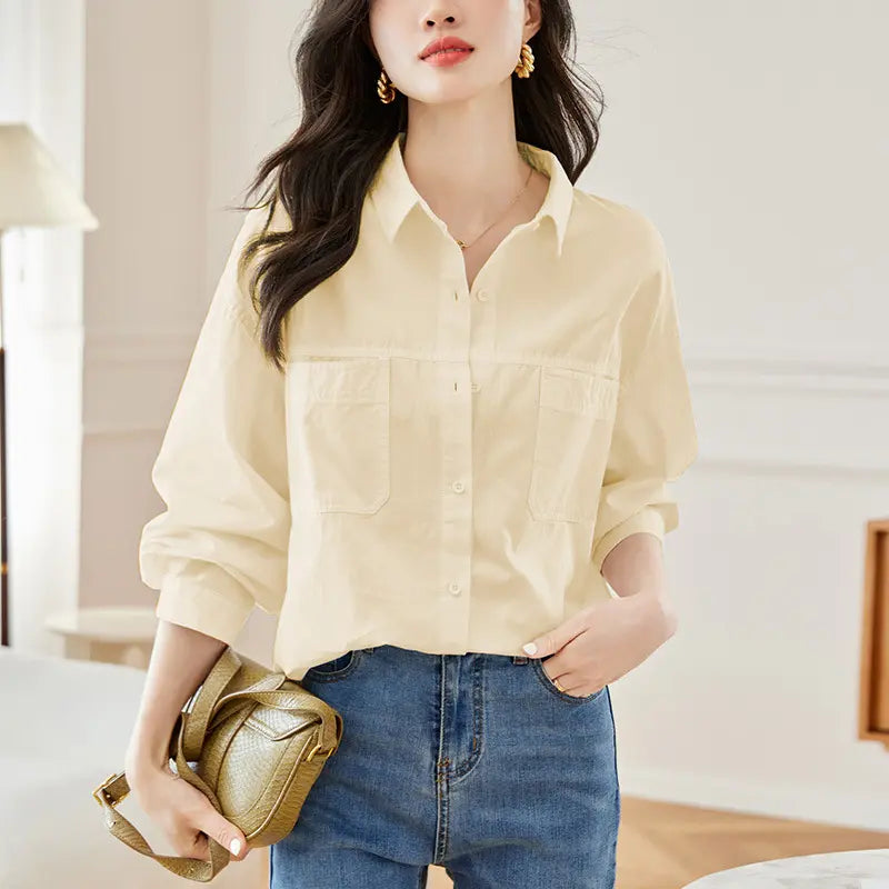 Woman wearing a Kaelix Yuzu Green long-sleeved cotton shirt with a relaxed fit, polo collar, dual chest pockets, and tonal buttons, paired with blue jeans and a gold handbag.