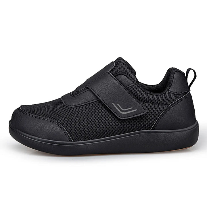 Kaelo black breathable mesh walking shoes with adjustable hook-and-loop strap and black EVA sole, shown from the side on a white background.